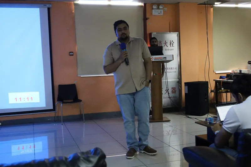 Trainer Awais Rafeeq presenting to a room of staff