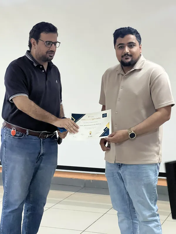 Awais Rafeeq receiving a certificate of appreciation at the Orange Line Metro session